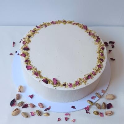 Luxurious, indulgent and tasty pistachio and white chocolate cake, sandwiched and coated with vegan vanilla buttercream, decorated with edible dried flower petals and chopped pistachios.