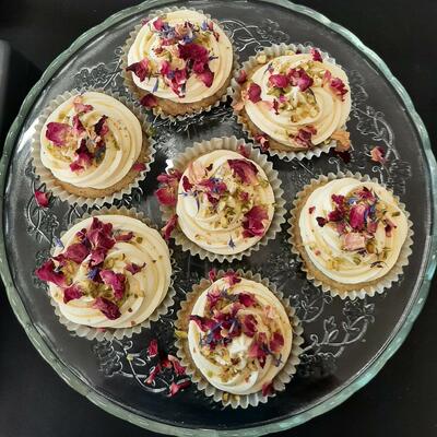 Decorated with vanilla flavoured buttercream, chopped pistachio nuts and edible dried rose petals.